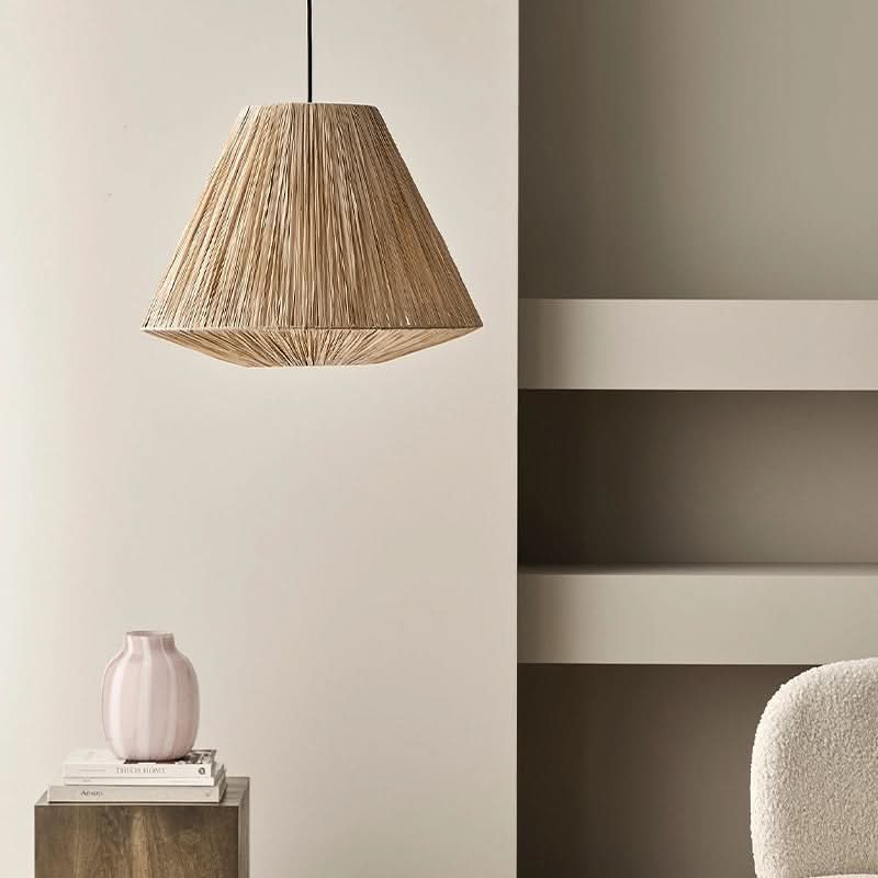 Natural raffia lampshade, triangular shape, hanging pendant light in a minimalist home decor setting.